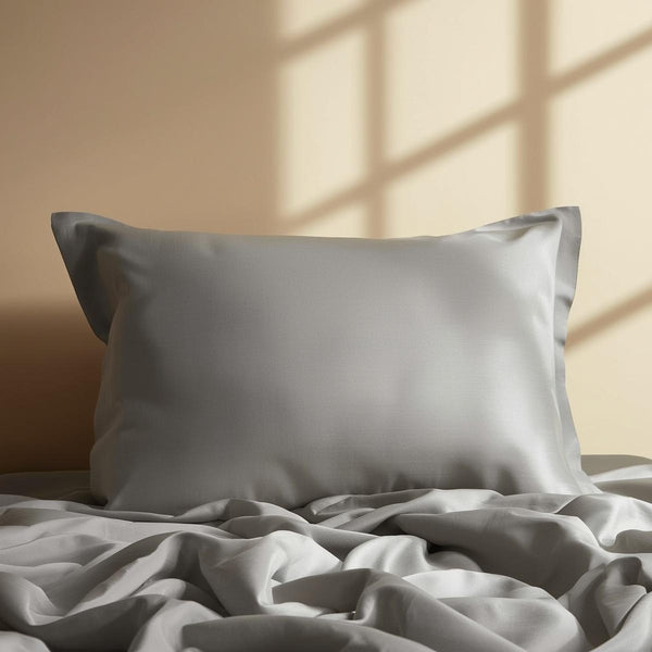 Single medium gray silk pillowcase displayed elegantly, soft natural lighting, warm neutral background, premium product photography, luxurious silk texture, no text or words.jpg